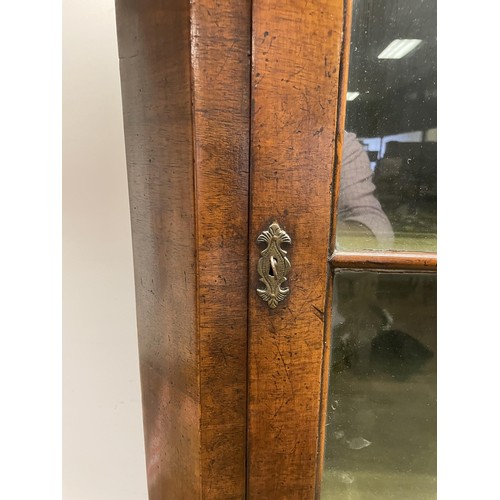 1565 - A walnut floor standing corner cupboard, 100 cm wide