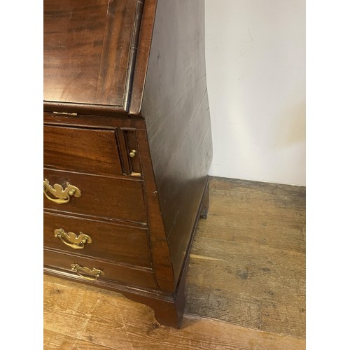 1564 - An 18th century mahogany bombe bureau bookcase, the top having two panel doors, to reveal adjustable... 