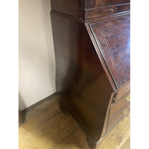 1564 - An 18th century mahogany bombe bureau bookcase, the top having two panel doors, to reveal adjustable... 