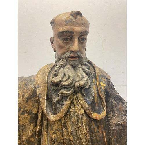 1618 - A large carved wood figure of a saint, with painted decoration, 119 cm high, possibly 16th century