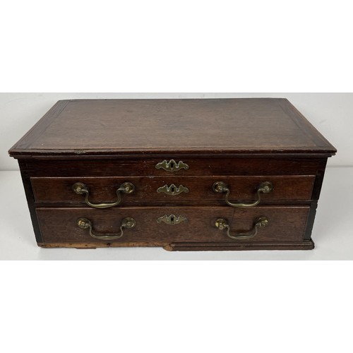 1373 - A 19th century oak table top chest, having a lift up top above two drawers, 60.5 cm wide, a carved s... 