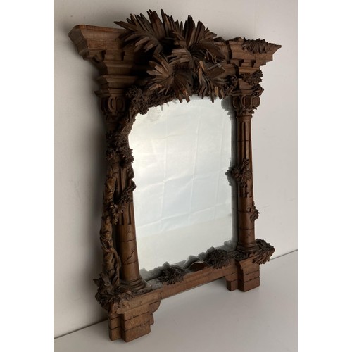 1679 - A late 19th/early 20th century carved walnut framed mirror, in the form of a overgrown ruin, 43 x 32... 