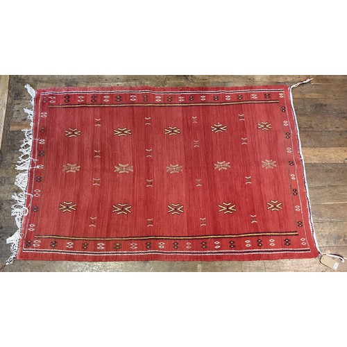 1702 - A red ground rug  193 x 132 cm