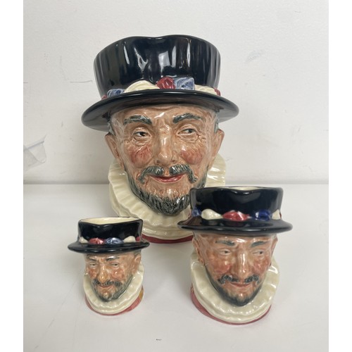 1489 - A graduated set of Royal Doulton Beefeater character jugs, with the rare yellow GR cypher handles an... 