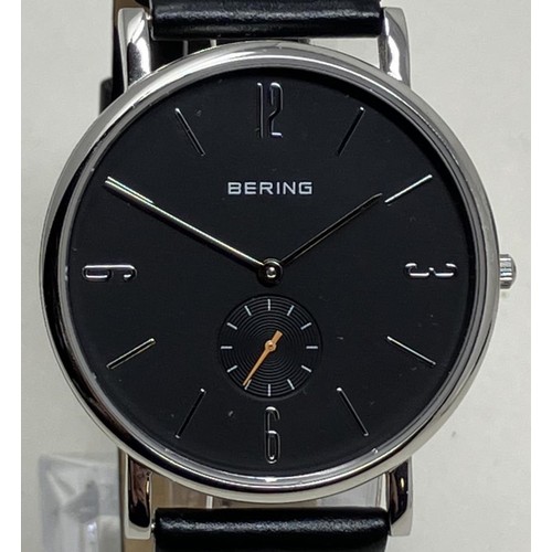 9 - A gentleman's stainless steel Bering wristwatch 13709-402, on a leather strap, in a glass case,... 