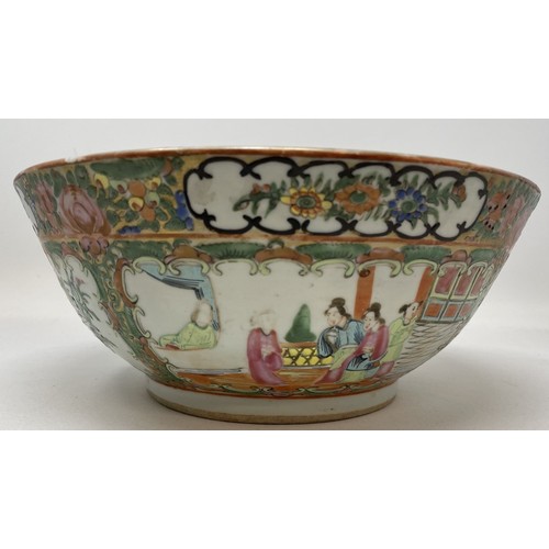 1501 - A Cantonese famille rose bowl, decorated figures and foliage, 27.5 cm diameter