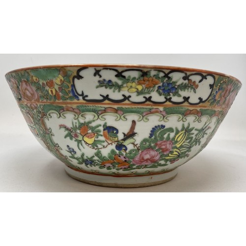 1501 - A Cantonese famille rose bowl, decorated figures and foliage, 27.5 cm diameter