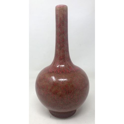 1506 - A Chinese red ground bottle vase, six character mark to base, 23 cm high