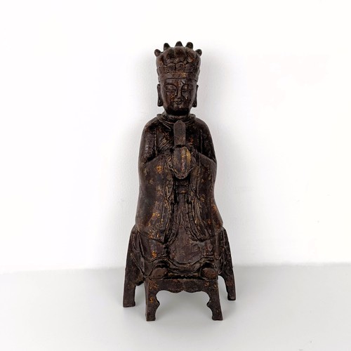 1557 - A Chinese Ming style iron buddha holding a sceptre, with splashed decoration, seal mark with six cha... 