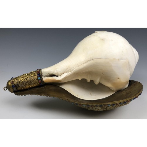 1594 - A Chinese conch shell trumpet, with a gilt bronze flange decorated in relief, with the eight Buddhis... 