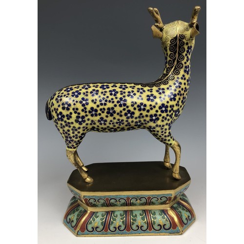 1597 - A Chinese cloisonné figure of a stag, standing on a lotus leaf style base, probably Qing Dynasty, 18... 