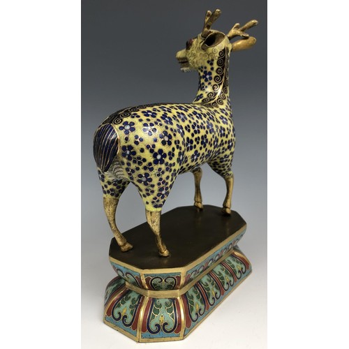 1597 - A Chinese cloisonné figure of a stag, standing on a lotus leaf style base, probably Qing Dynasty, 18... 