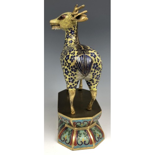 1597 - A Chinese cloisonné figure of a stag, standing on a lotus leaf style base, probably Qing Dynasty, 18... 