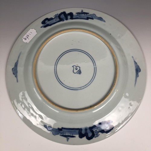 1603 - A Chinese blue and white plate, decorated huntsmen on horseback, 26.5 cm diameter