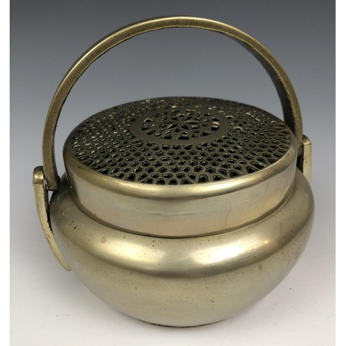 1607 - A Chinese metal censer and cover, with a swing handle, 12.5 cm diameter