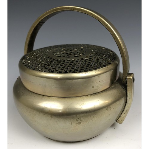 1607 - A Chinese metal censer and cover, with a swing handle, 12.5 cm diameter