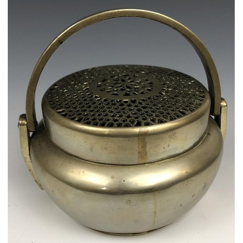 1607 - A Chinese metal censer and cover, with a swing handle, 12.5 cm diameter