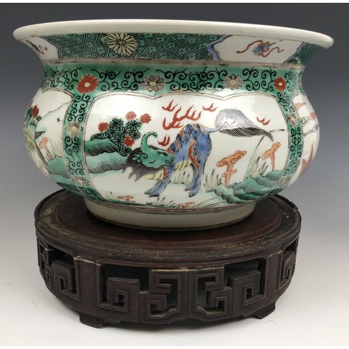 1609 - A Chinese famille verte bowl, decorated beasts, six character mark to base, 20 cm diameter, on a car... 