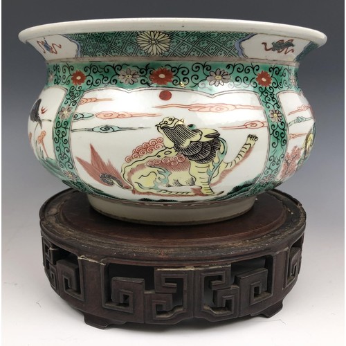 1609 - A Chinese famille verte bowl, decorated beasts, six character mark to base, 20 cm diameter, on a car... 