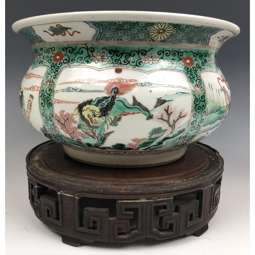 1609 - A Chinese famille verte bowl, decorated beasts, six character mark to base, 20 cm diameter, on a car... 