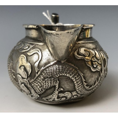 1622 - A Chinese silver coloured metal cream jug, embossed a dragon and with a faux bamboo handle, 5 cm hig... 