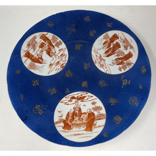 1505 - A Chinese powder blue charger, with three roundels, decorated figures in ironstone red, 40 cm diamet... 