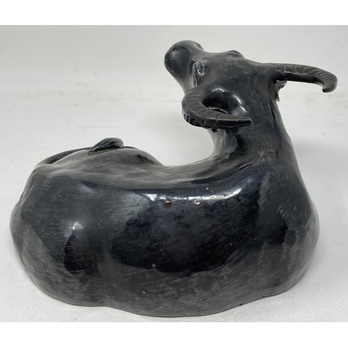 1508 - A Chinese pottery figure, of a recumbent water buffalo, on a hardwood stand, 17 cm high, and two Chi... 