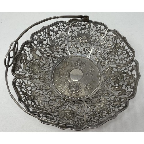 1507 - A Chinese silver coloured metal swing handled basket, with a simulated bamboo handle, the base embos... 