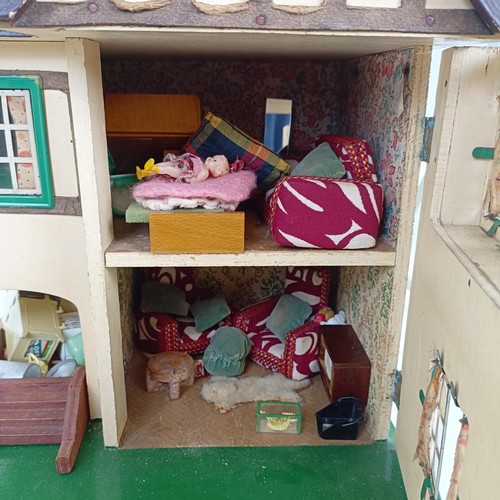 1912 - A Tri-ang style dolls house, assorted furniture, a doll size highchair, and a dolls tea set (qty)