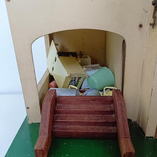 1912 - A Tri-ang style dolls house, assorted furniture, a doll size highchair, and a dolls tea set (qty)