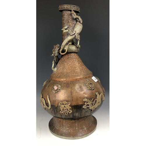 1546 - An Eastern brass oil lamp, 60 cm wide, and a brass and copper vase, decorated dragons, 49 cm high an... 