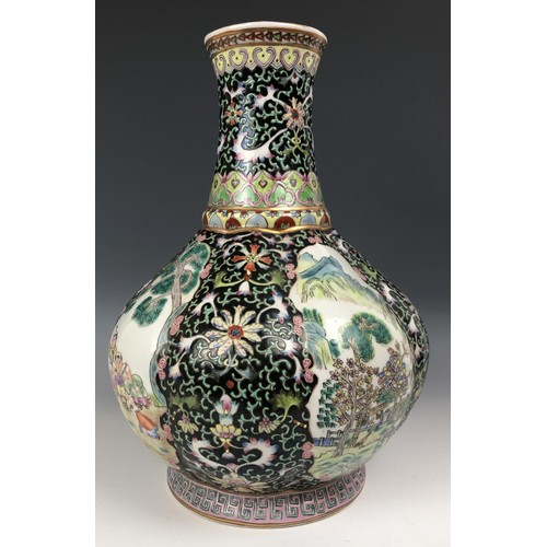 1577 - A Chinese famille noire vase, decorated figures, 30 cm high