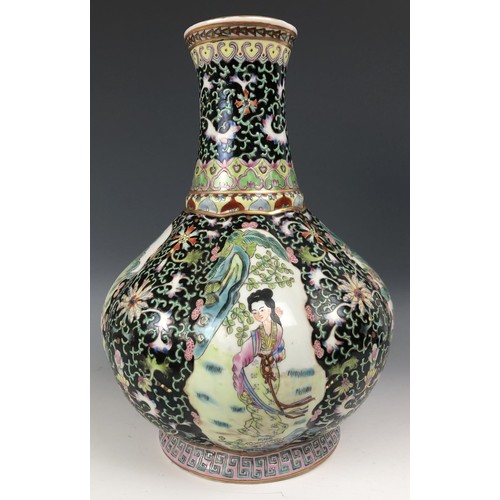 1577 - A Chinese famille noire vase, decorated figures, 30 cm high