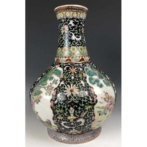 1577 - A Chinese famille noire vase, decorated figures, 30 cm high