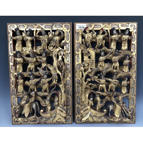 1576 - A pair of Chinese carved panels, decorated figures, highlighted in gilt, 40 x 25 cm, and a pair of c... 