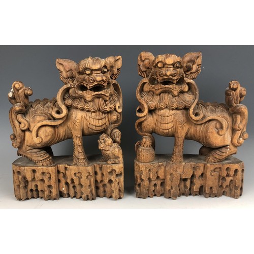 1576 - A pair of Chinese carved panels, decorated figures, highlighted in gilt, 40 x 25 cm, and a pair of c... 