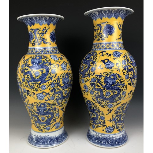 1573 - A matched pair of Chinese yellow ground vases, six character marks to the bases, 47 cm and 48 cm (2)