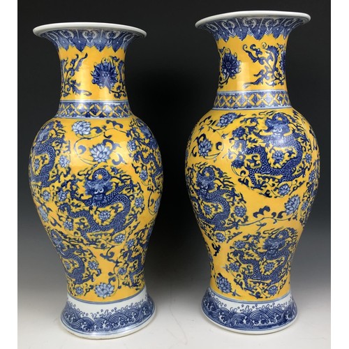 1573 - A matched pair of Chinese yellow ground vases, six character marks to the bases, 47 cm and 48 cm (2)