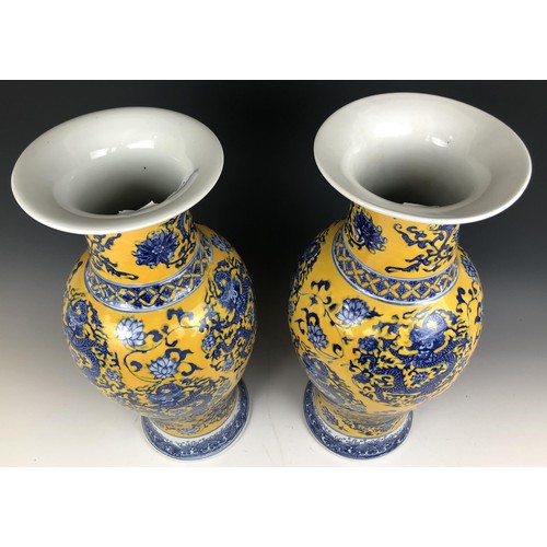 1573 - A matched pair of Chinese yellow ground vases, six character marks to the bases, 47 cm and 48 cm (2)