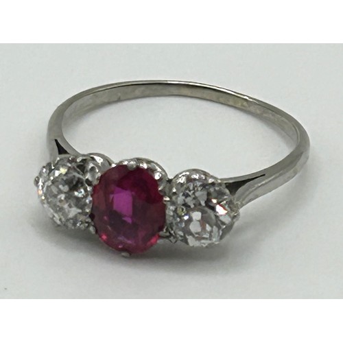 417 - A white coloured metal, synthetic ruby and diamond three stone ring, ring size P