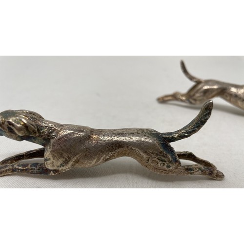 719 - A pair of novelty silver knife rests, in the form of running hounds