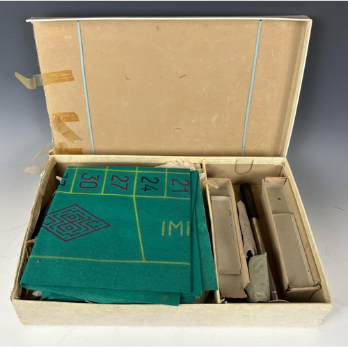 698 - A table top roulette wheel, boxed, two Boules sets, two air pistols and two daggers (box)