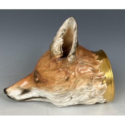 721 - A large 19th century porcelain fox head stirrup cup, probably Worcester or Derby, 17 cm high Provena... 