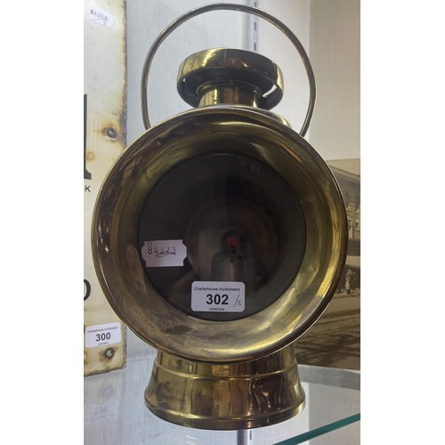 302 - An S F E Napier (1907) vintage brass motor lamp, 34 cm high, and a photograph, of an American ceremo... 