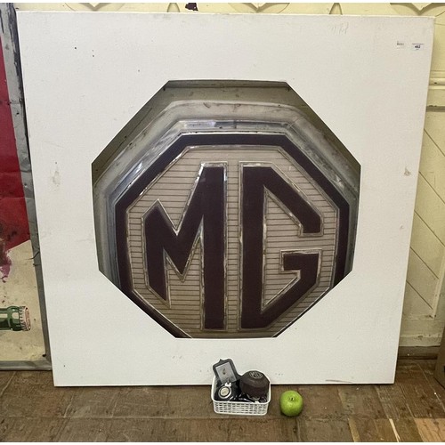 462 - An MG showroom sign, 95 cm wide, and an associated metal frame, 120 cm wide, an MG car badge and oth... 