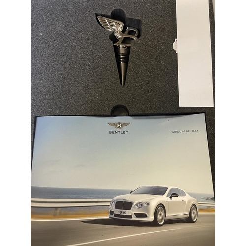 425 - A Bentley wine bottle stopper, in the form of a winged B, boxed with paperwork, and Bentley Continen... 