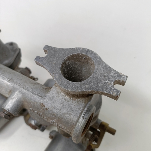 256 - A pair of 1 1/4 inch SU carburettors, 6 inches between centres, on a manifold