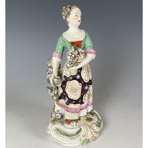 1858 - A porcelain figure of a young woman, 20 cm high, and another figure, 23 cm high (2)