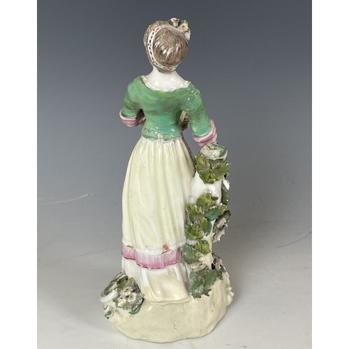 1858 - A porcelain figure of a young woman, 20 cm high, and another figure, 23 cm high (2)