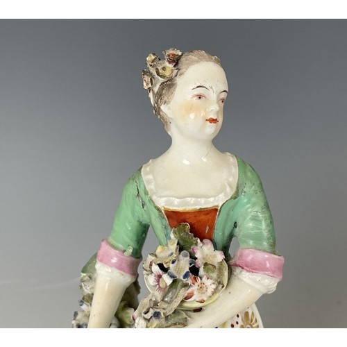 1858 - A porcelain figure of a young woman, 20 cm high, and another figure, 23 cm high (2)